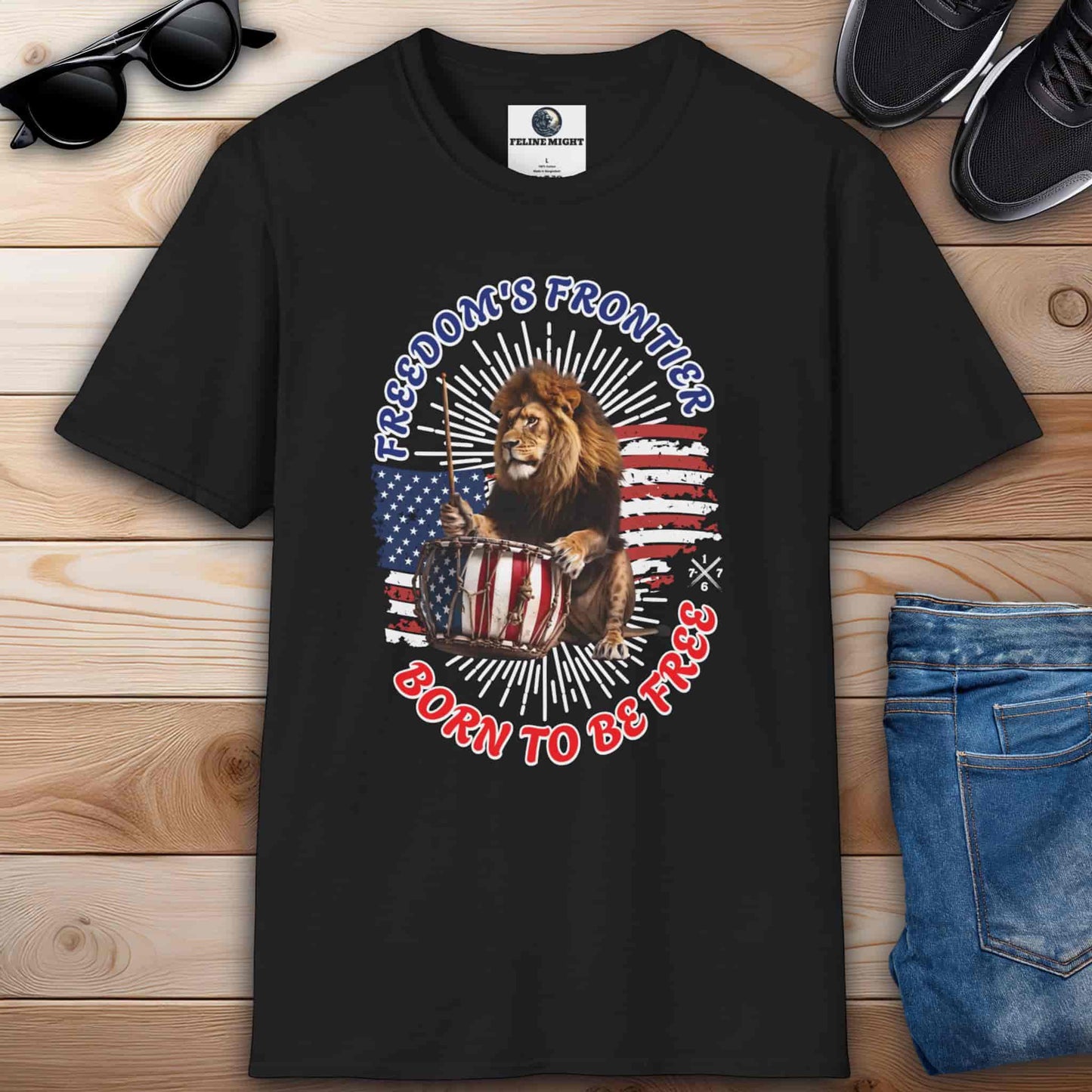 Black T-shirt with the slogan 'Born to Be Free' and a graphic design featuring the American flag and a lion playing the drums.