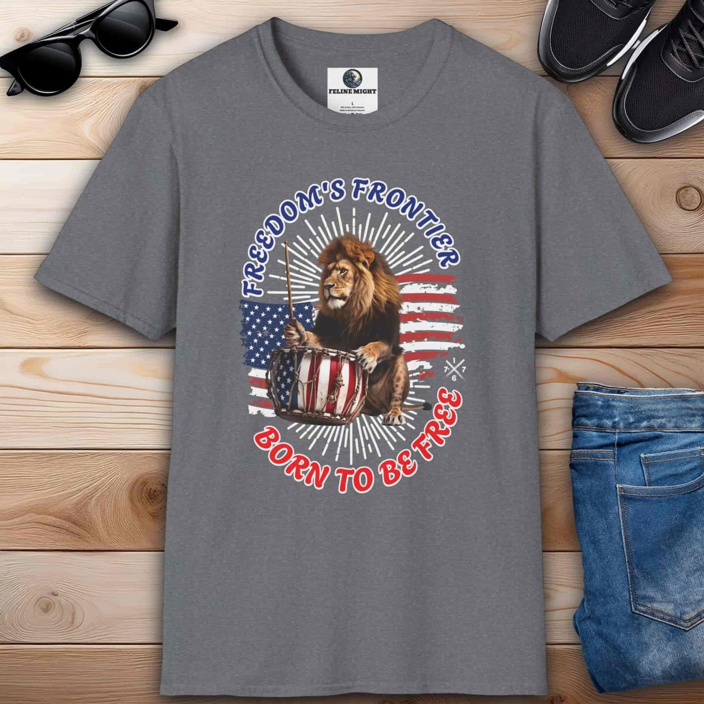 Gray T-shirt with the slogan 'Born to Be Free' and a graphic design featuring the American flag and a lion playing the drums.