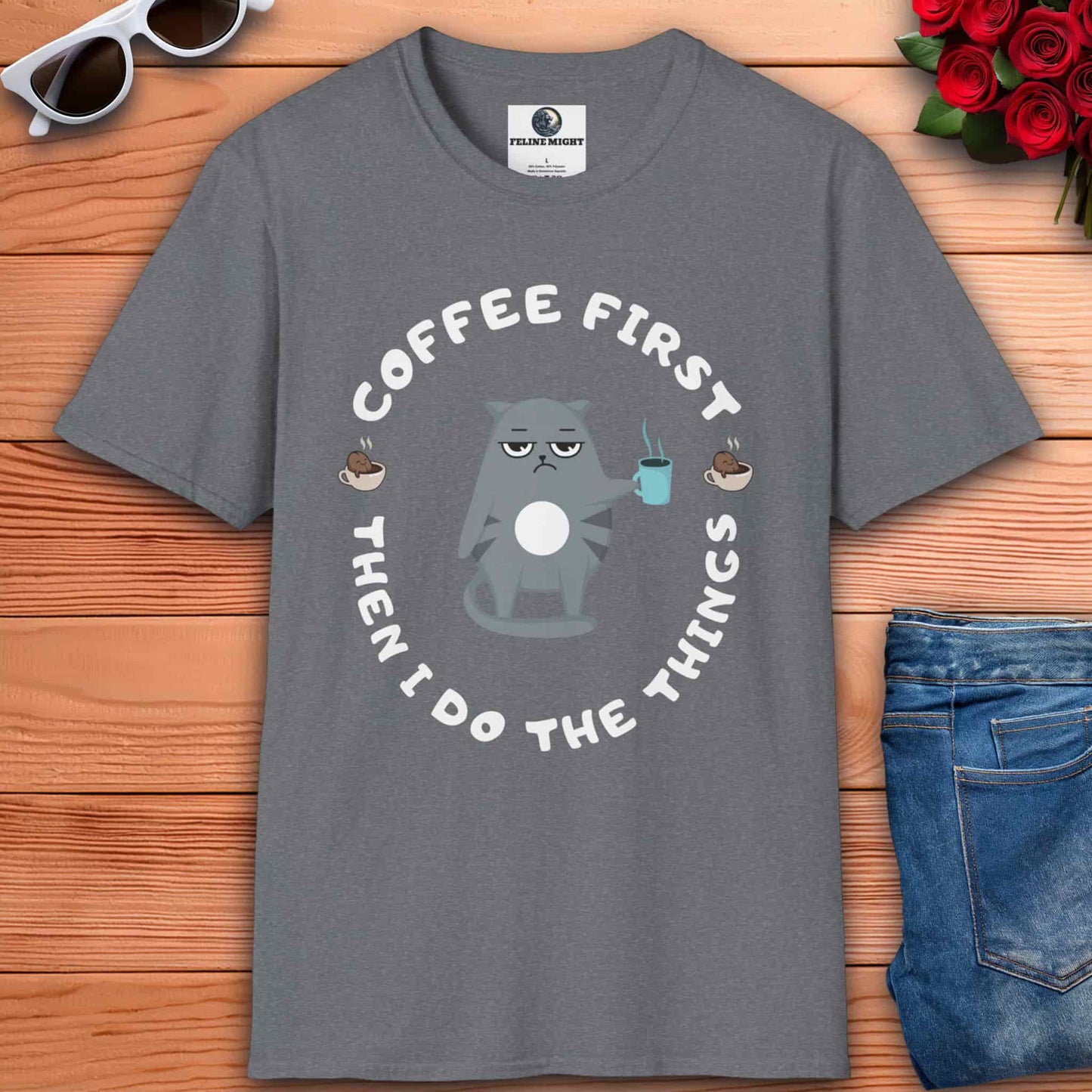 An athletic heather grey t-shirt featuring the phrase "Coffee first, then I do the things" in a stylish font, perfect for coffee lovers.