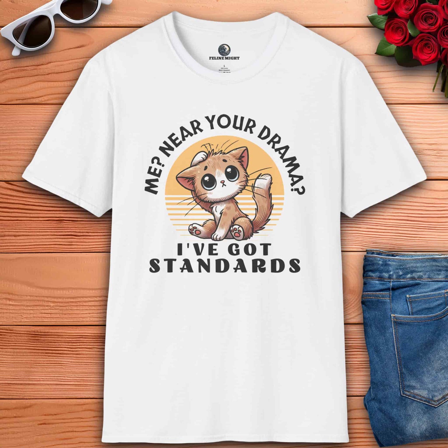 White t-shirt featuring a cute cat illustration with the text 'Me? Near your drama? I've got standards.'
