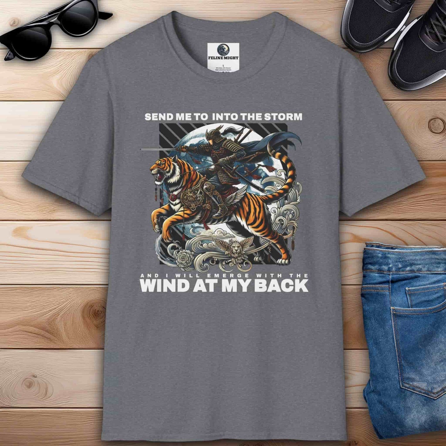 Athletic heather grey t-shirt with a warrior riding a tiger and the phrase "Send me into the storm and I will emerge with the wind at my back", inspired by adventure and courage.