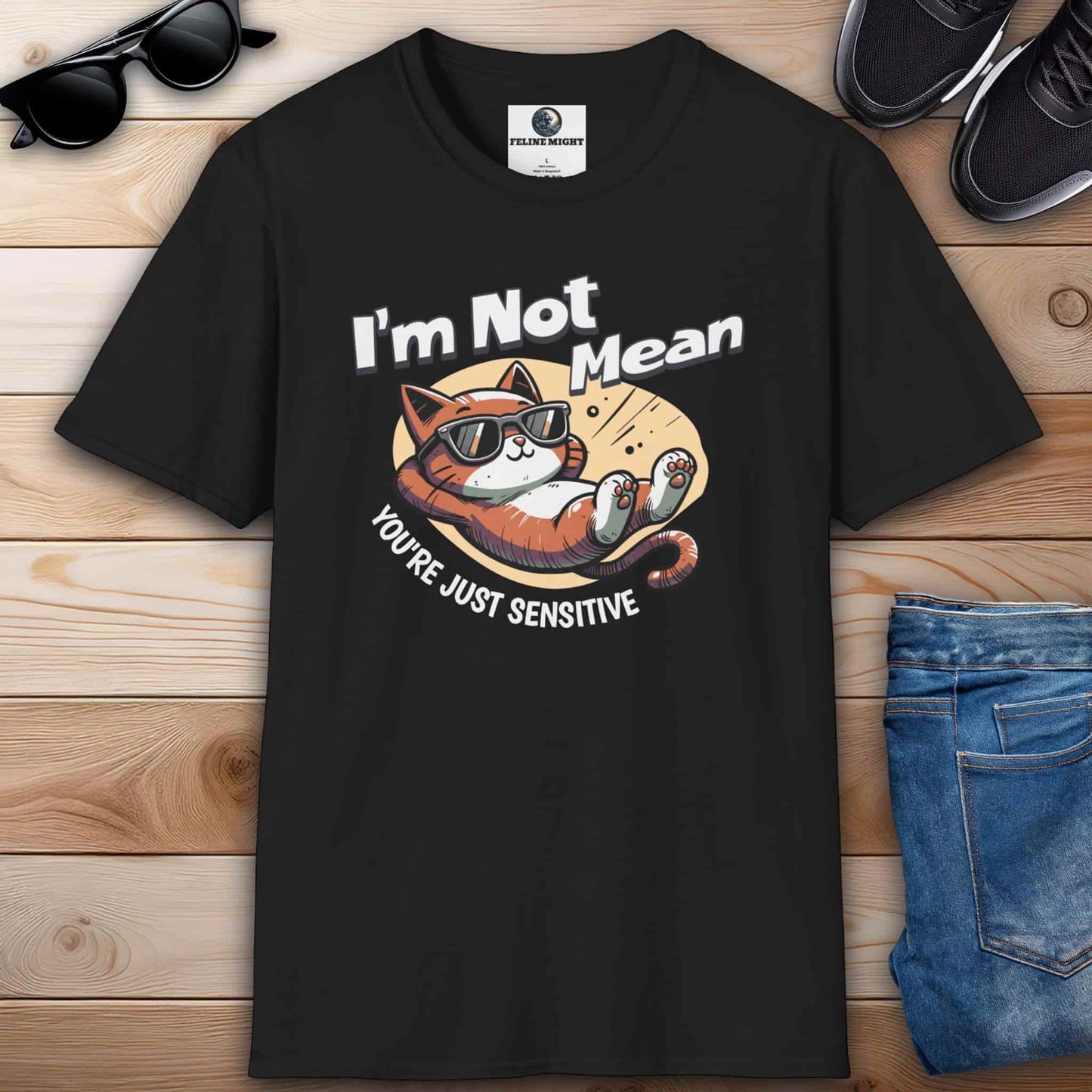 A humorous black t-shirt featuring a laid-back cat wearing sunglasses with the text 'I'm Not Mean, You're Just Sensitive'