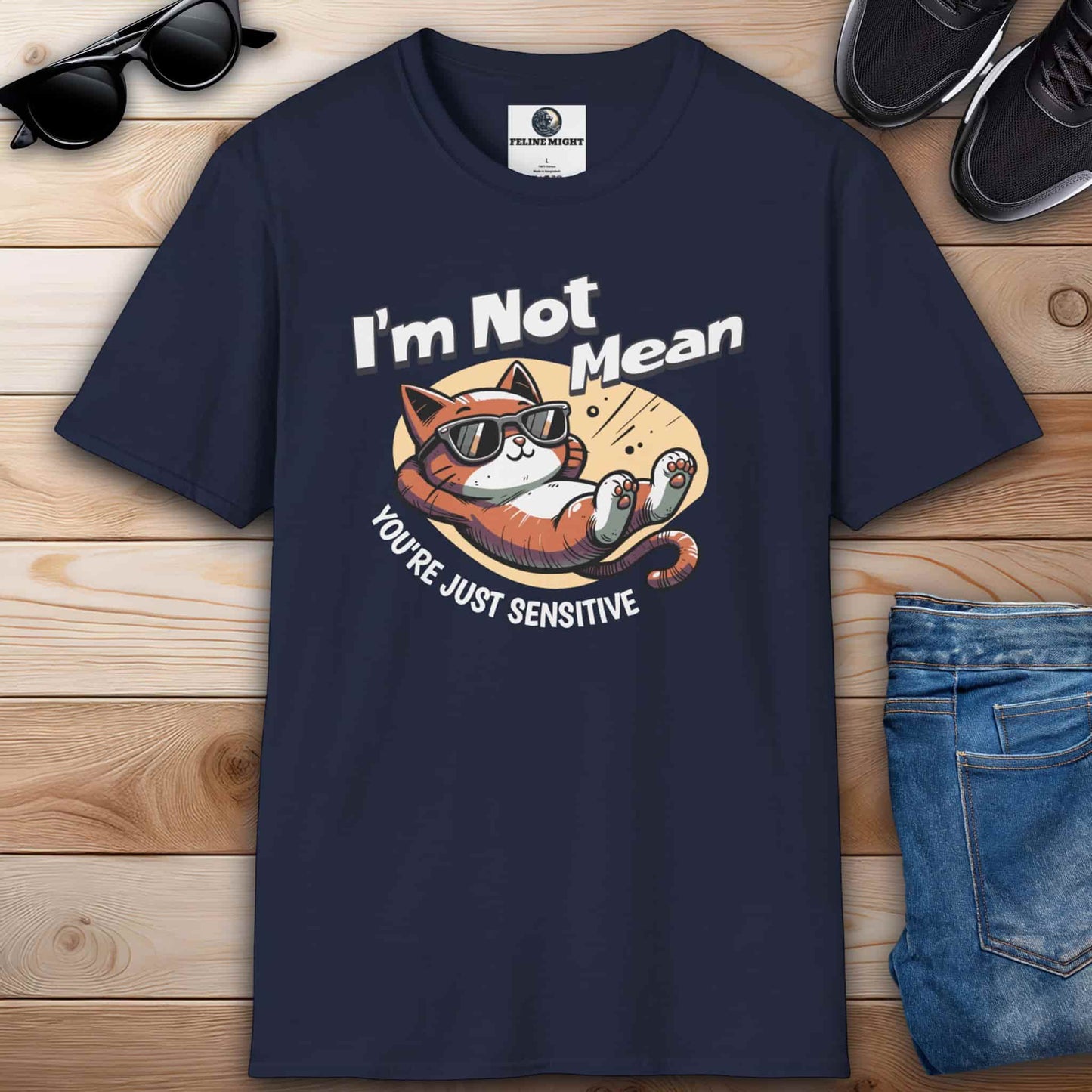 A humorous navy blue t-shirt featuring a laid-back cat wearing sunglasses with the text 'I'm Not Mean, You're Just Sensitive'