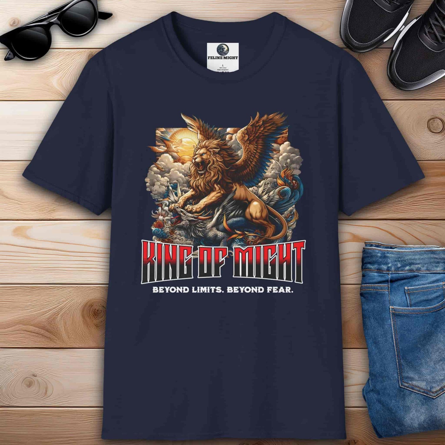 Navy blue t-shirt featuring a winged lion and dragon design with the text 'King of Might' and 'Beyond Limits. Beyond Fear.'