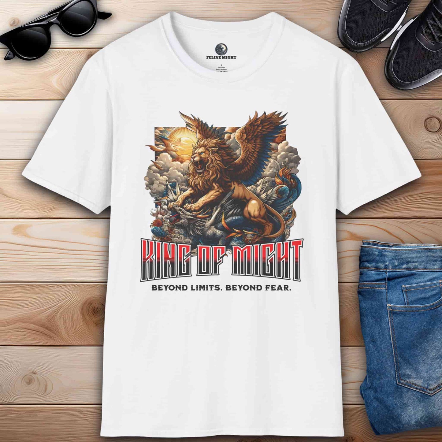 White t-shirt featuring a winged lion and dragon design with the text 'King of Might' and 'Beyond Limits. Beyond Fear.'