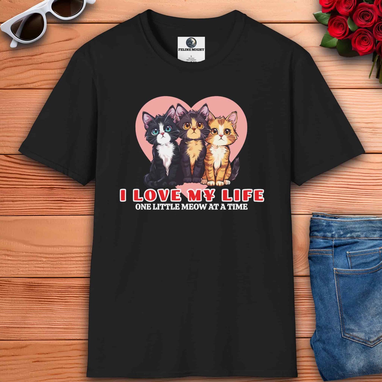 Black t-shirt featuring three cute cats and the phrase 'I Love My Life, One Little Meow at a Time' with a heart background.