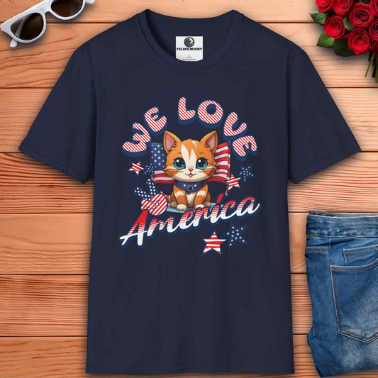 Navy blue t-shirt featuring cute cat design with 'We Love America' text and patriotic elements