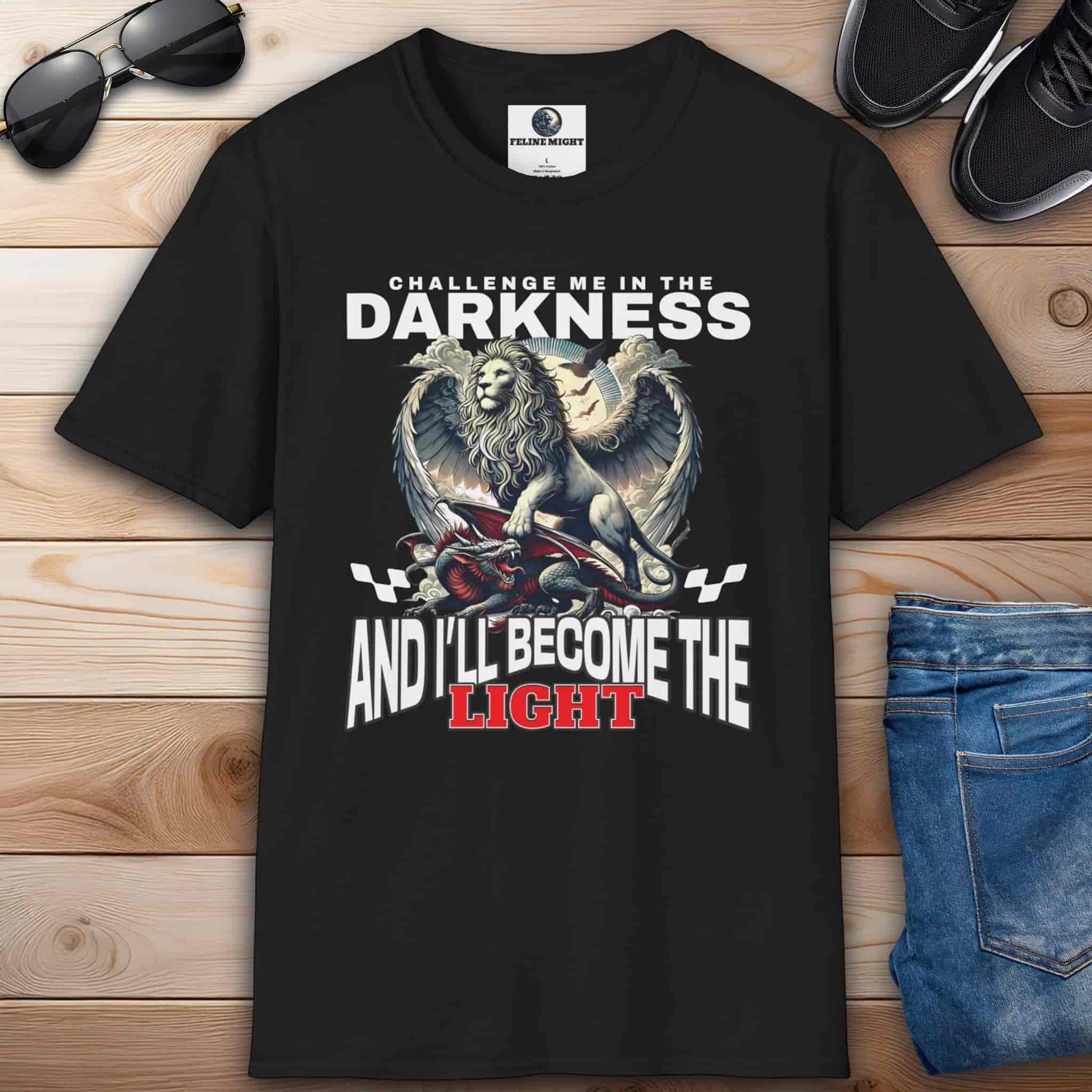A Black "Challenge Me" Lion T-Shirt featuring a majestic winged lion graphic and the text "Challenge me in the Darkness and I'll Become the Light".
