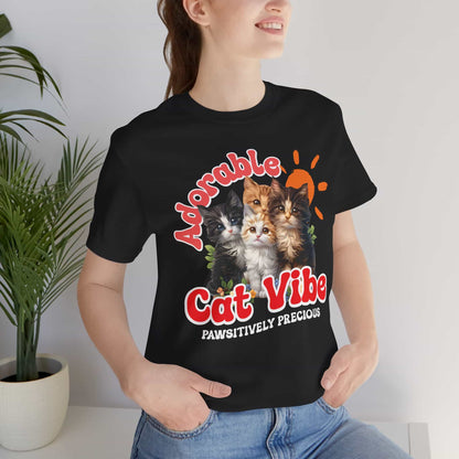 A close-up of a woman wearing a black Adorable Cat Vibe T-Shirt featuring four cute cats, perfect for cat lovers who embrace their feline passion.