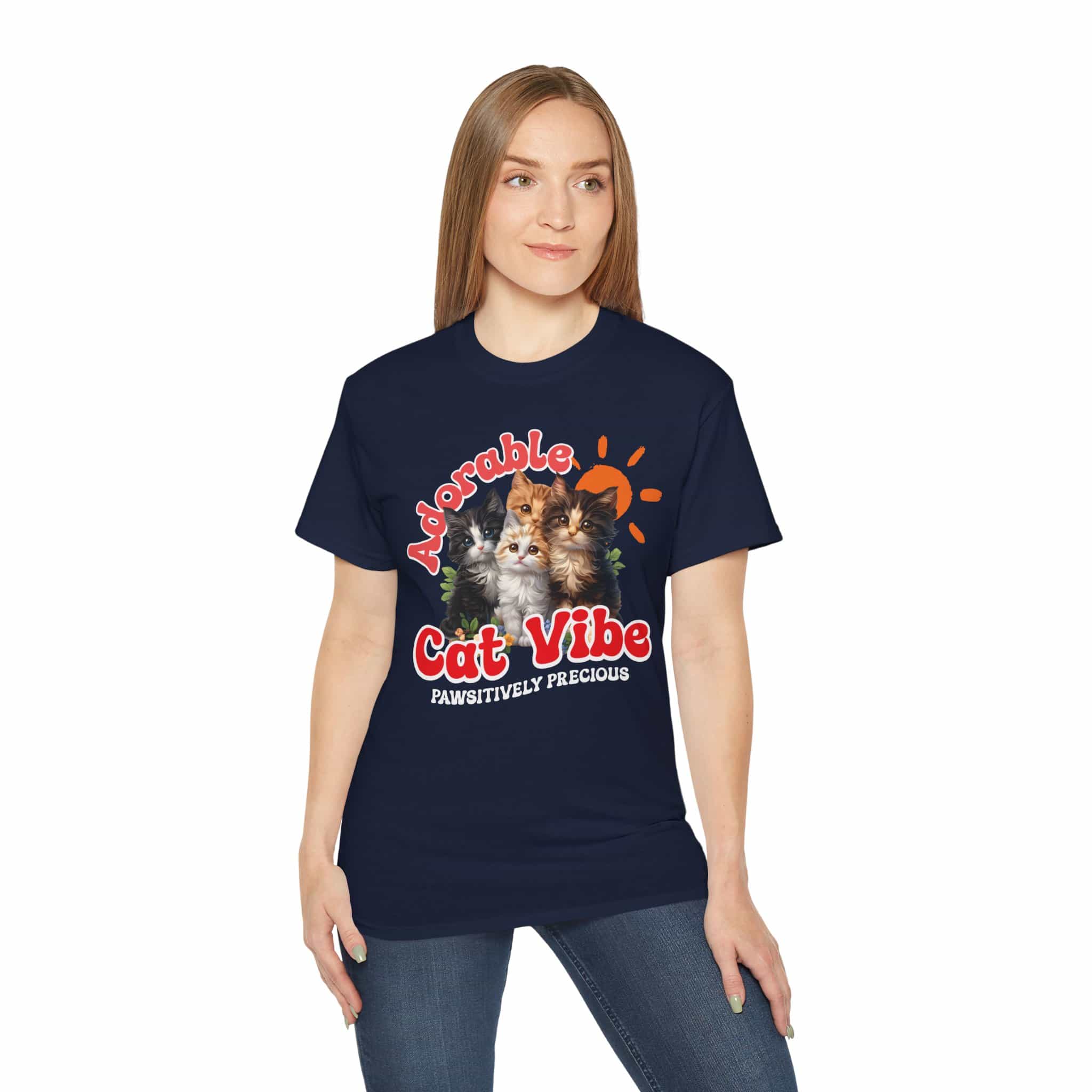 A woman wearing a navy blue Adorable Cat Vibe Graphic T-Shirt featuring four cats, perfect for cat lovers who embrace their feline passion.