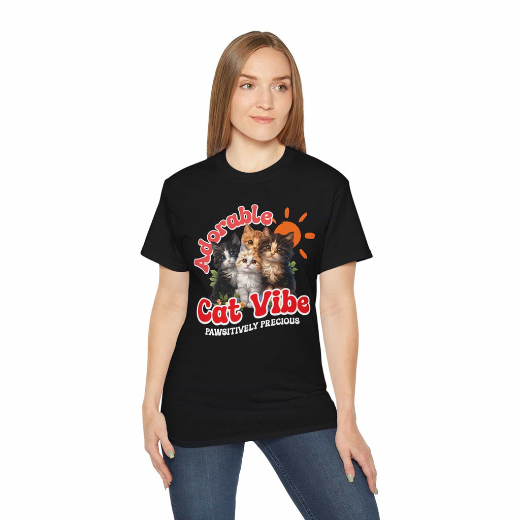 A woman wearing a black Adorable Cat Vibe Graphic T-Shirt featuring four cats, perfect for cat lovers who embrace their feline passion.
