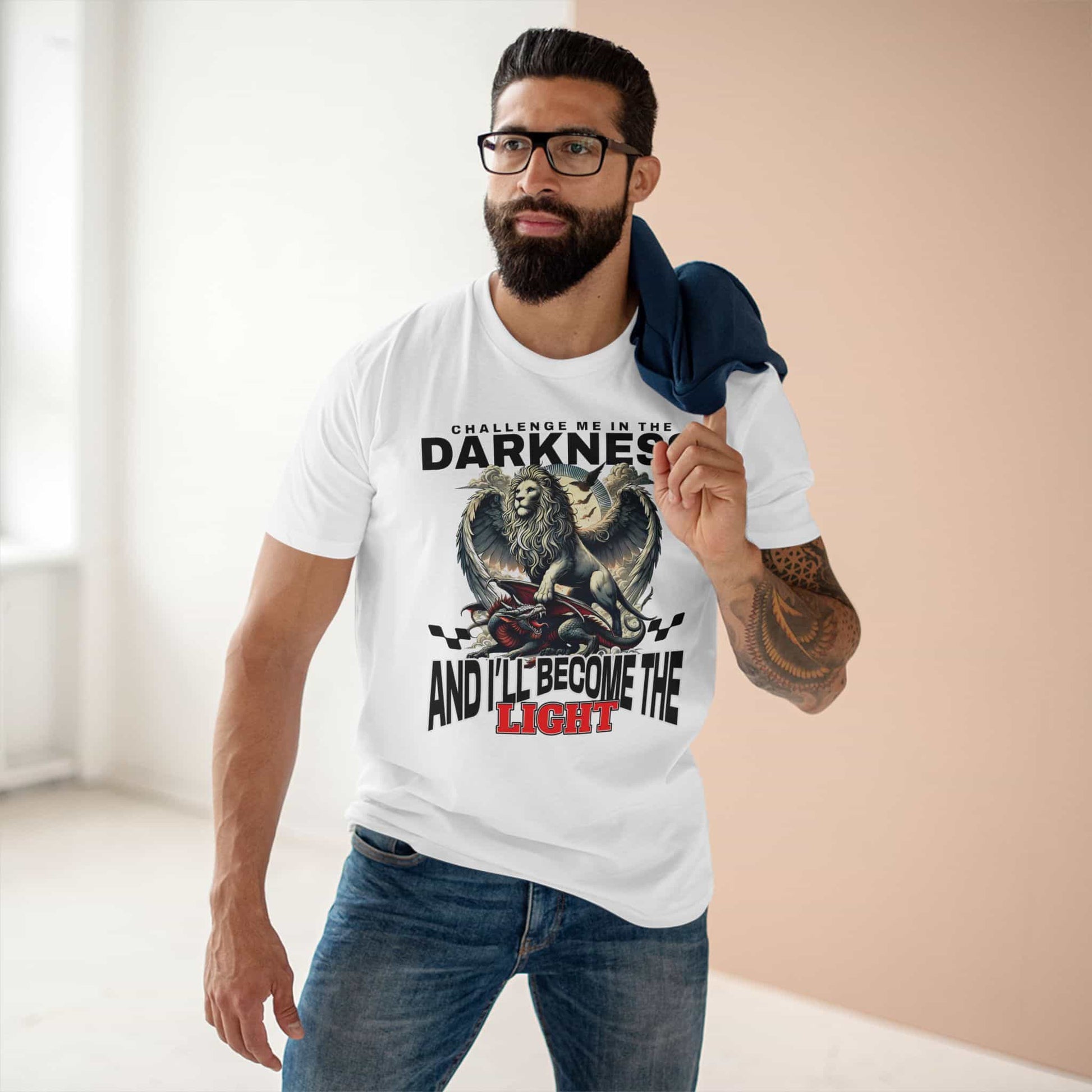A man wearing a white Challenge Me in the Darkness Lion T-Shirt featuring a majestic winged lion graphic.
