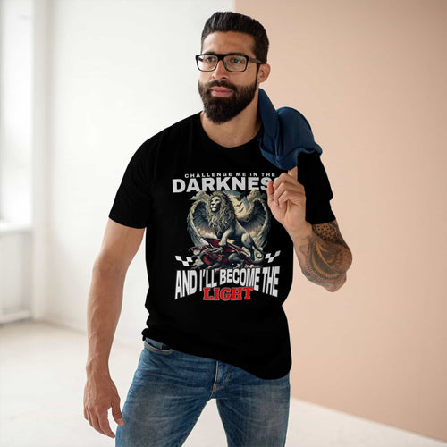 A man wearing a Black "Challenge Me" Lion T-Shirt featuring a majestic winged lion graphic and the text "Challenge me in the Darkness and I'll Become the Light".