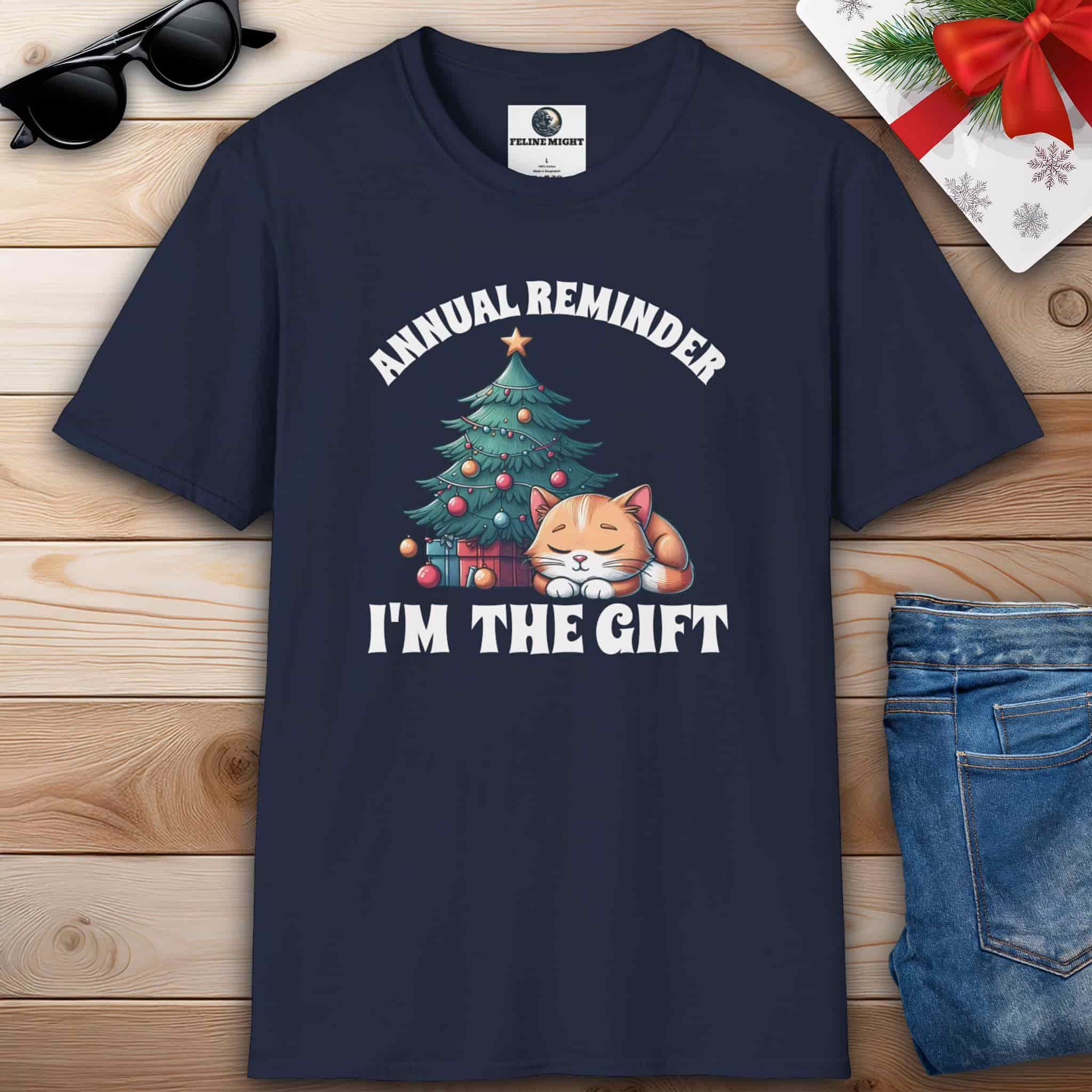 Navy blue t-shirt with 'Annual Reminder, I'm the Gift' and a cute cat sleeping beside a Christmas tree.