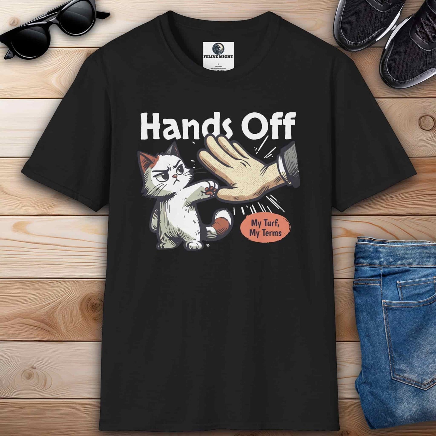 Black graphic t-shirt featuring a cat and the phrase “Hands off, my turf, my terms,” ideal for expressing confidence and humor.