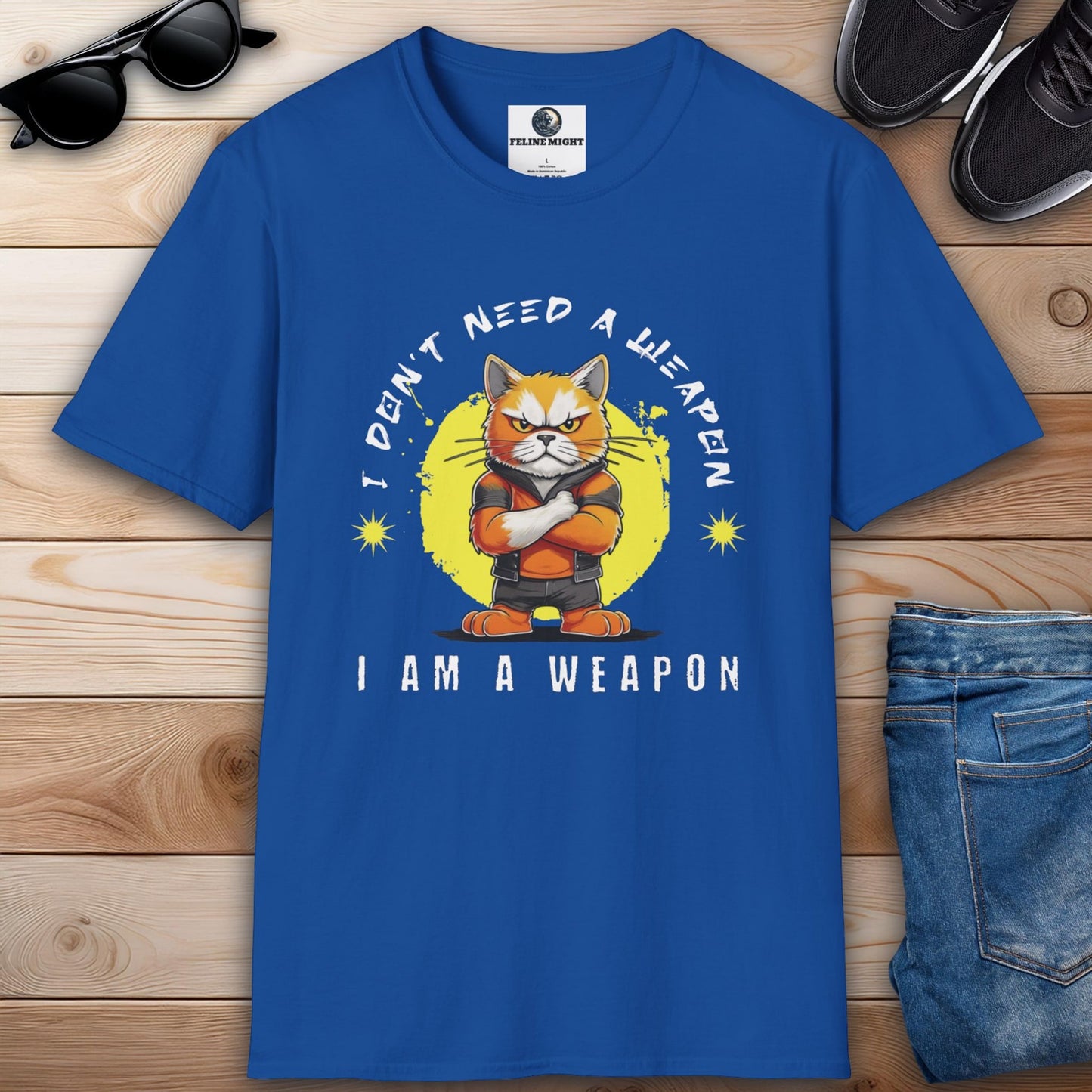 Royal blue t-shirt featuring a cartoon cat with the phrase 'I Don't Need A Weapon, I Am A Weapon'