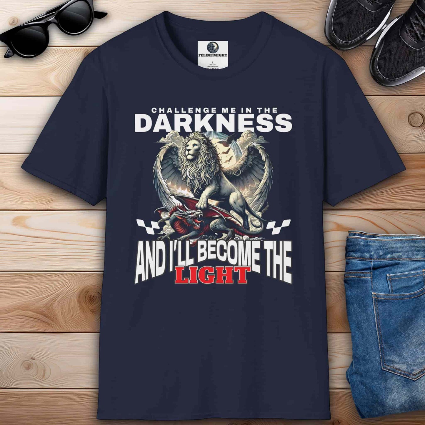 A navy blue Challenge Me in the Darkness Lion T-Shirt featuring a winged lion graphic with the text 'Challenge me in the darkness and I will become the light.'