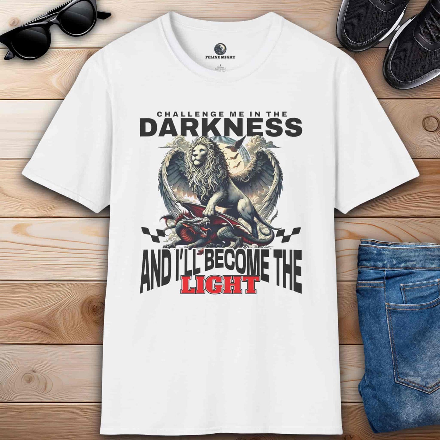 A white Challenge Me in the Darkness Lion T-Shirt featuring a winged lion graphic with the text 'Challenge me in the darkness and I will become the light.'