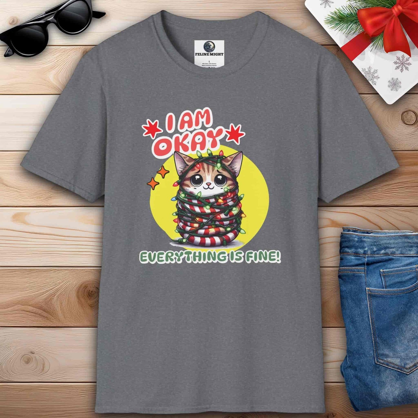 A grey T-shirt featuring a cat that humorously states, "I am Okay. Everything is fine!" spreading joy and laughter during the holiday season.