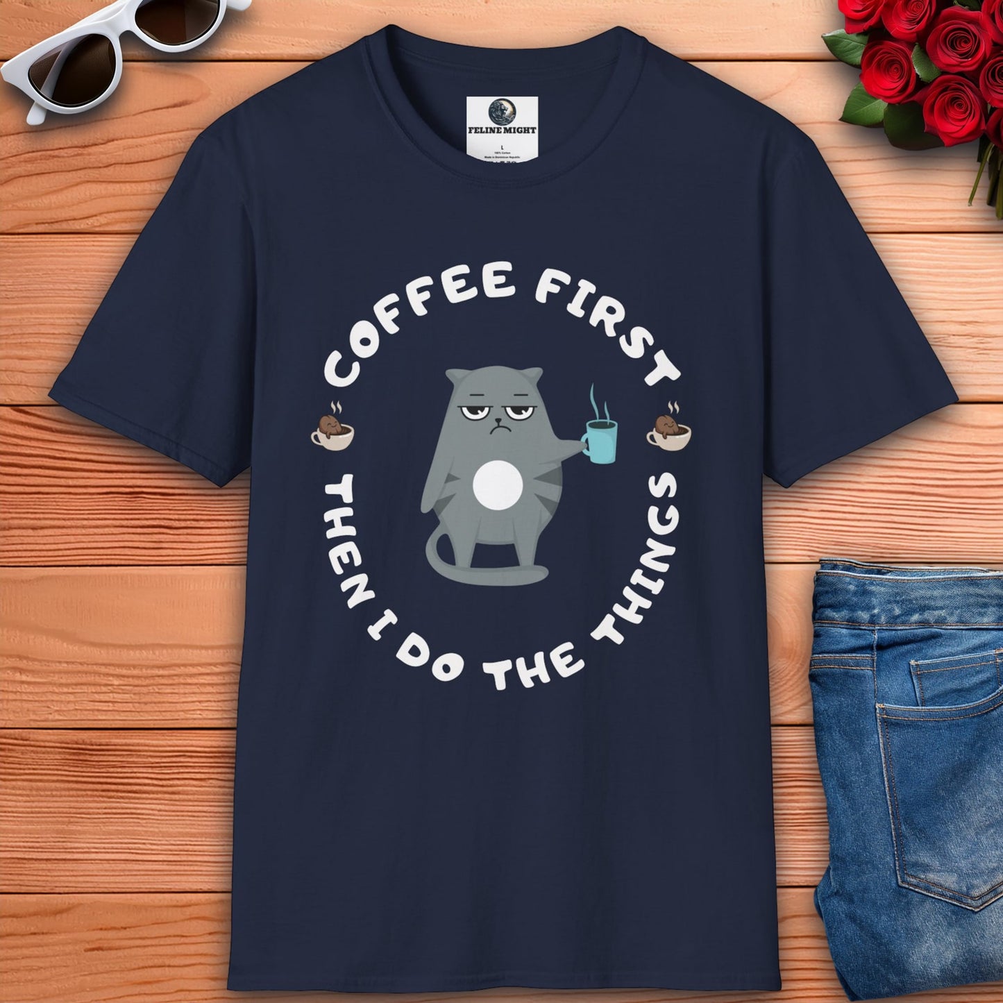 A navy blue t-shirt featuring the phrase "Coffee first, then I do the things" in a stylish font, perfect for coffee lovers.