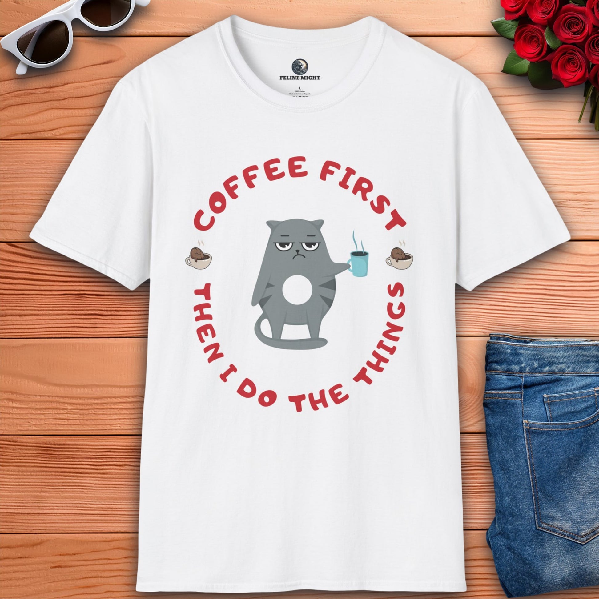 A white t-shirt featuring the phrase "Coffee first, then I do the things" in a stylish font, perfect for coffee lovers.