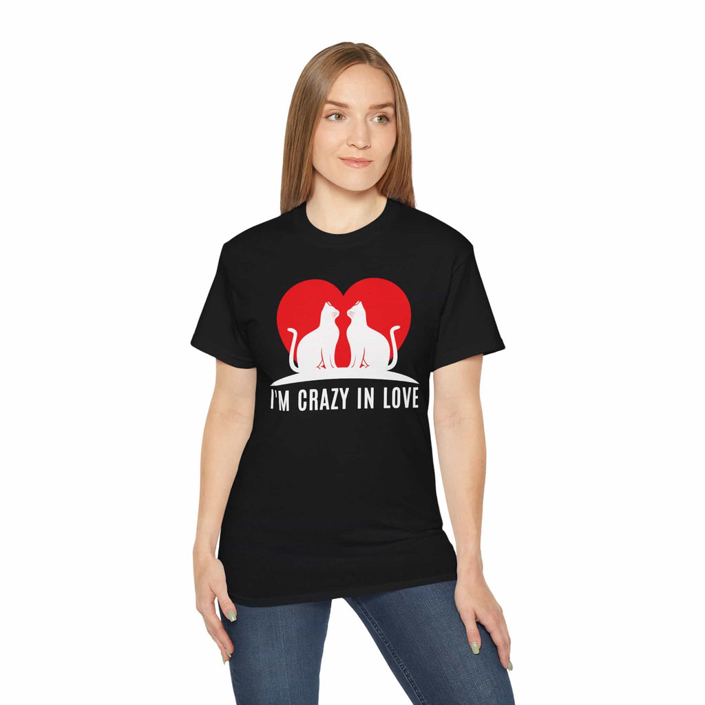 A woman wearing a black I'm Crazy in Love Cat T-Shirt featuring two cats with a heart design, perfect for romantic cat lovers.