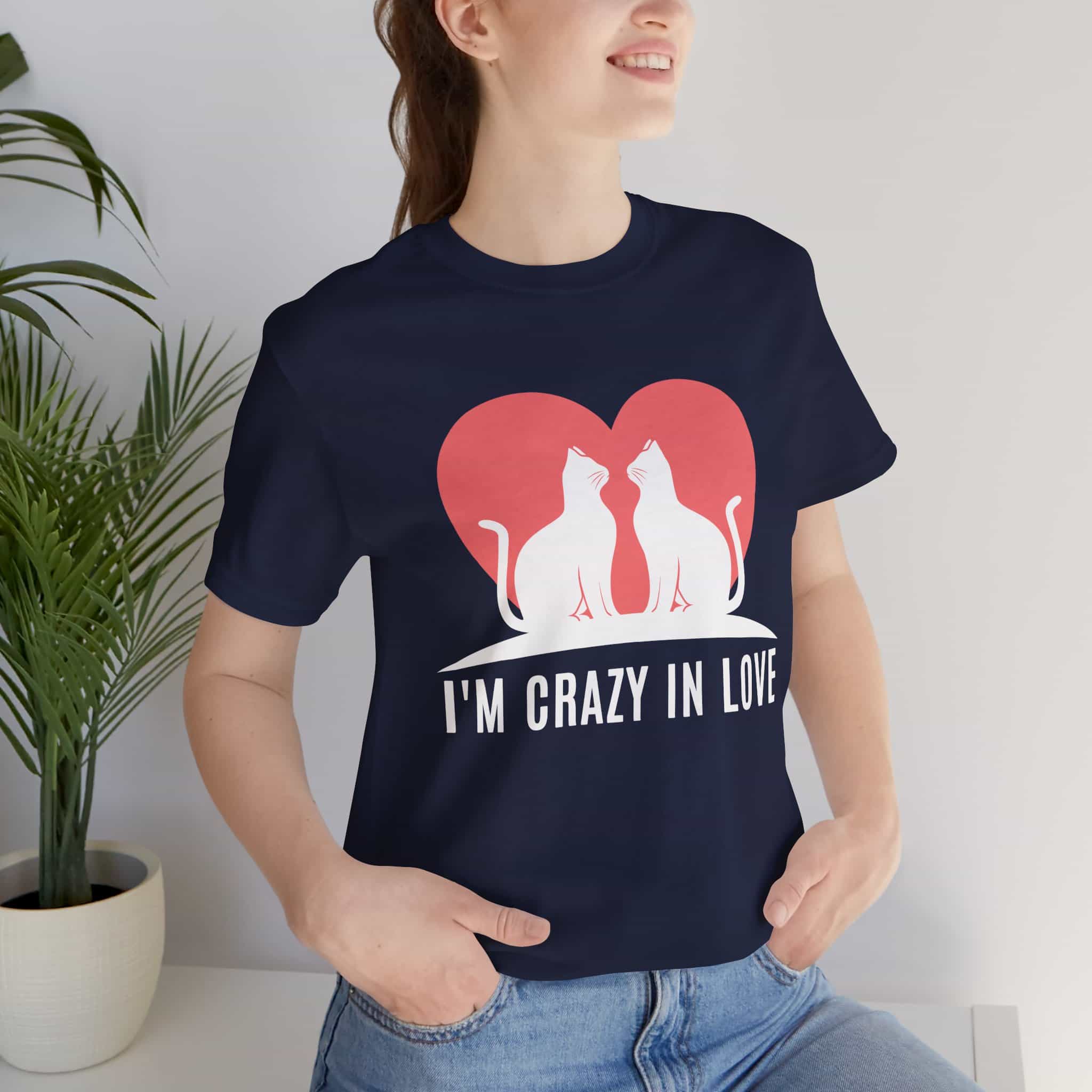 A woman in a navy blue I'm Crazy in Love Cat T-Shirt featuring two cats with a heart design, perfect for romantic cat lovers.