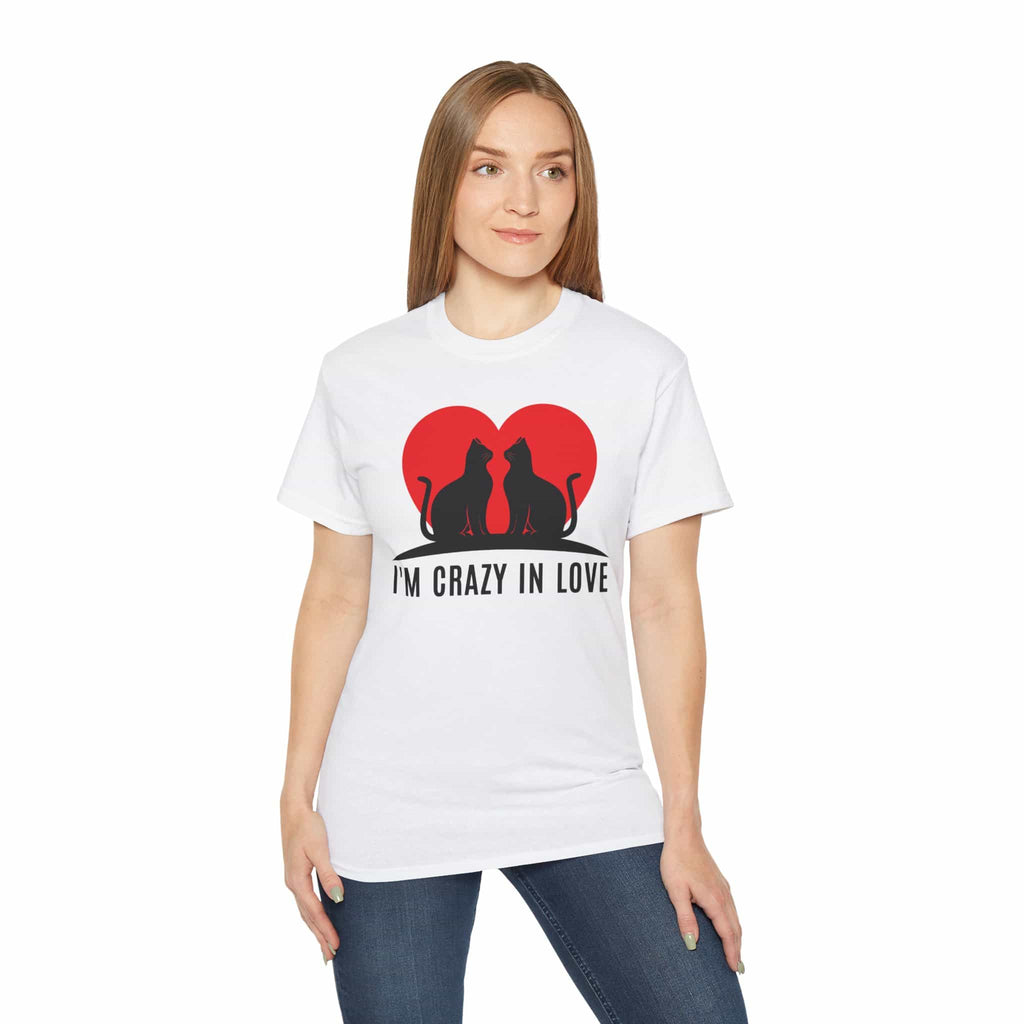 A woman wearing a white I'm Crazy in Love Cat T-Shirt featuring two cats with a heart design, perfect for romantic cat lovers.