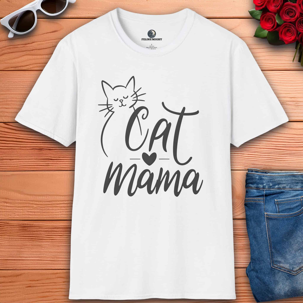 A white Sweet Cat Mama Graphic T-Shirt with 'Cat Mama' design on a wooden surface with sunglasses and flowers.