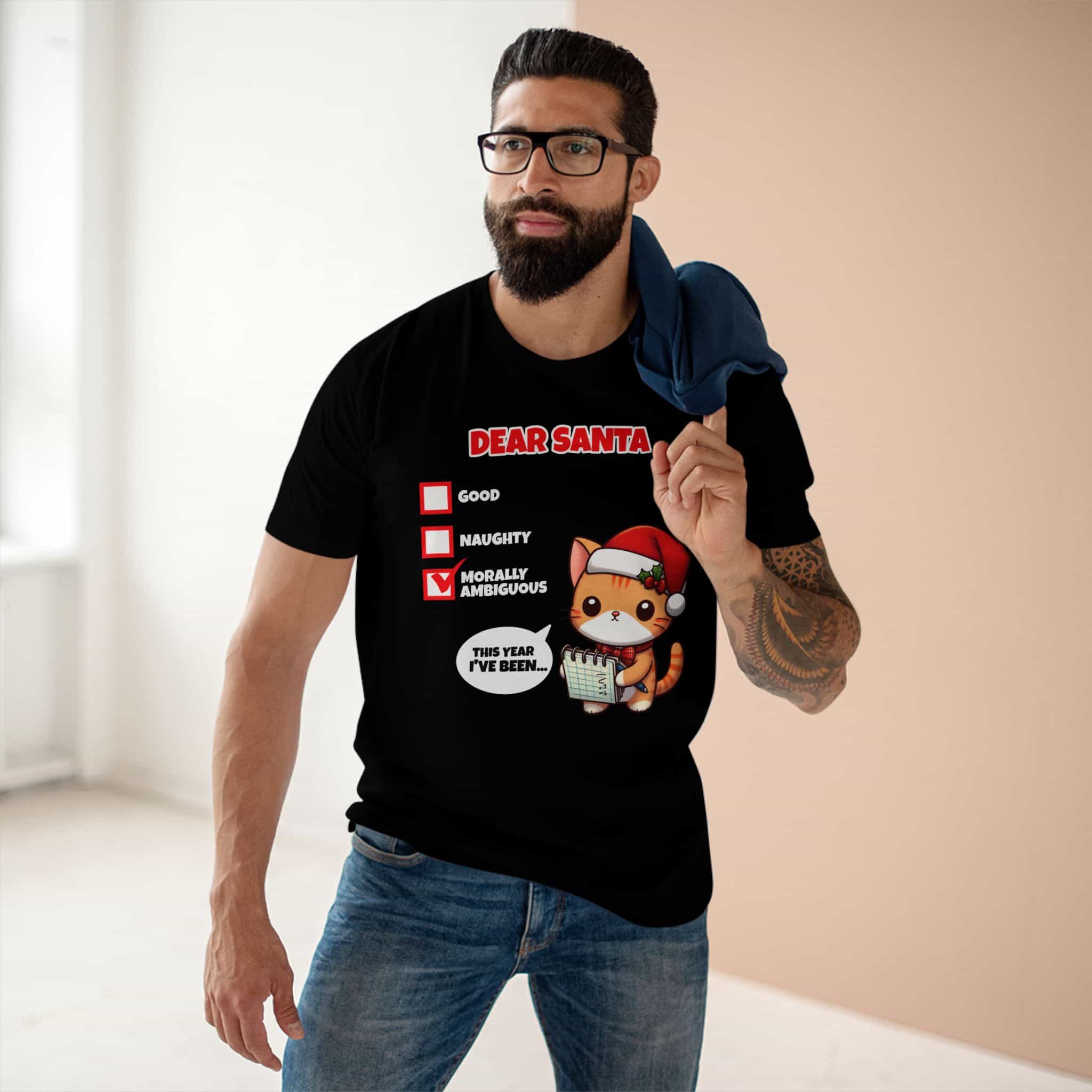 A man wearing a black Dear Santa Funny Cat T-Shirt featuring a cute cat illustration and festive humor.