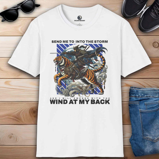 White t-shirt with a warrior riding a tiger and the phrase "Send me into the storm and I will emerge with the wind at my back", inspired by adventure and courage.