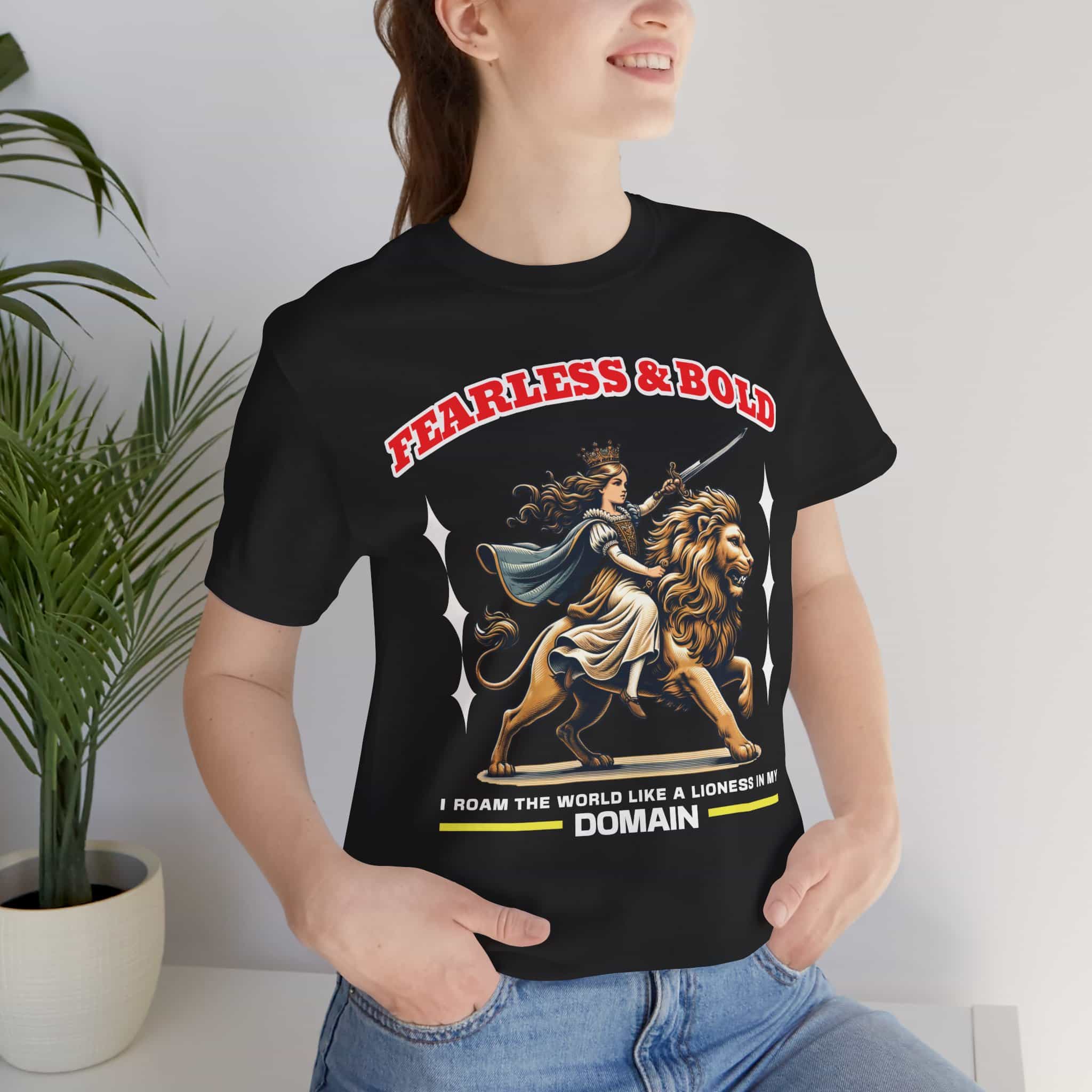 A woman wearing a black Fearless Lioness Women's T-Shirt featuring a sword-wielding queen and lion design.