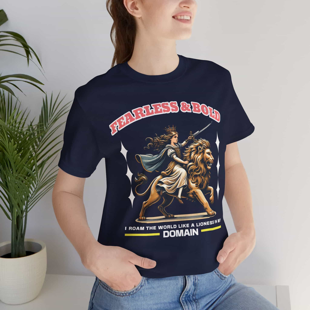 A woman wearing a navy blue Fearless Lioness Women's T-Shirt featuring a sword-wielding queen and lion design.