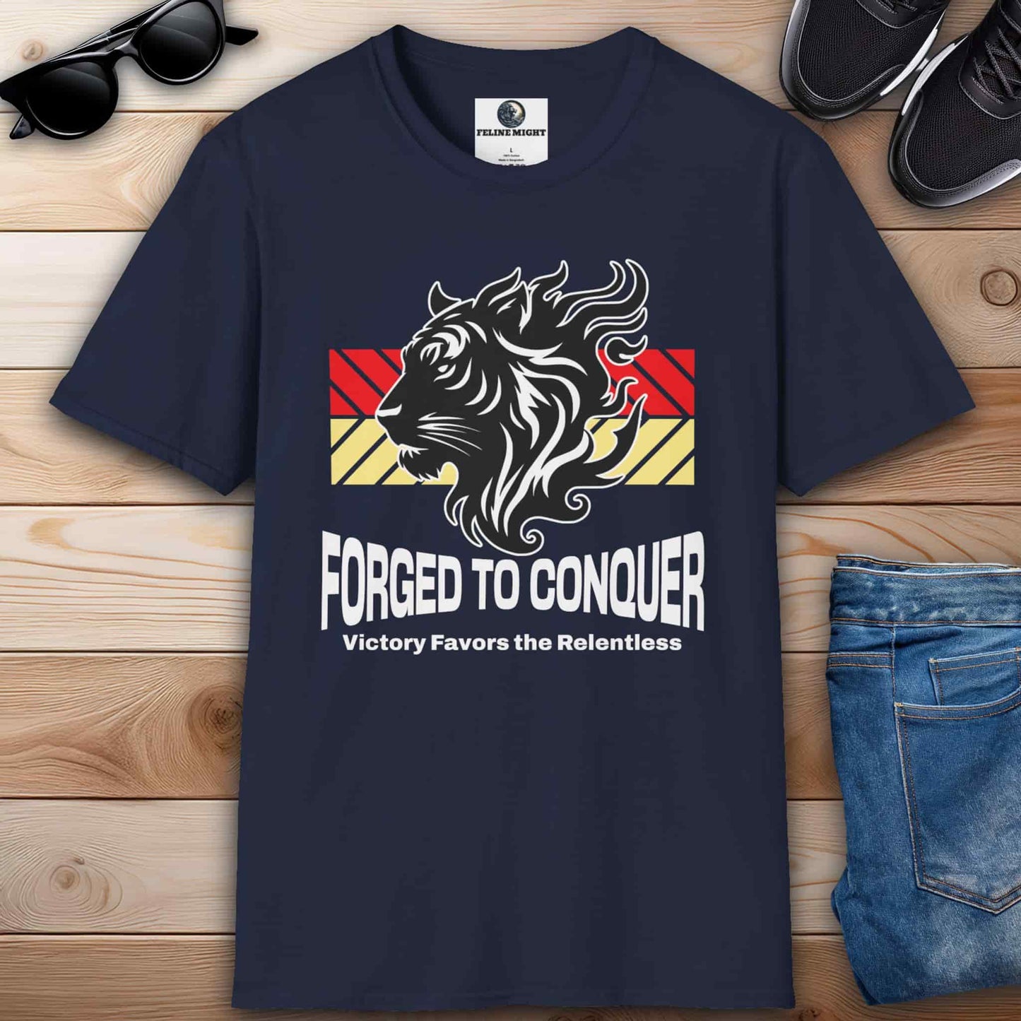 A navy blue Forged to Conquer Tiger t-shirt featuring a fierce tiger design and the text 'Victory favors the relentless,' representing strength and resilience.