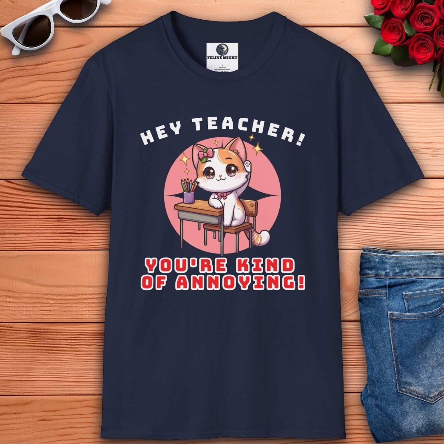 A cute cat character on a navy blue t-shirt saying 'Hey Teacher! You're Kind of Annoying!'