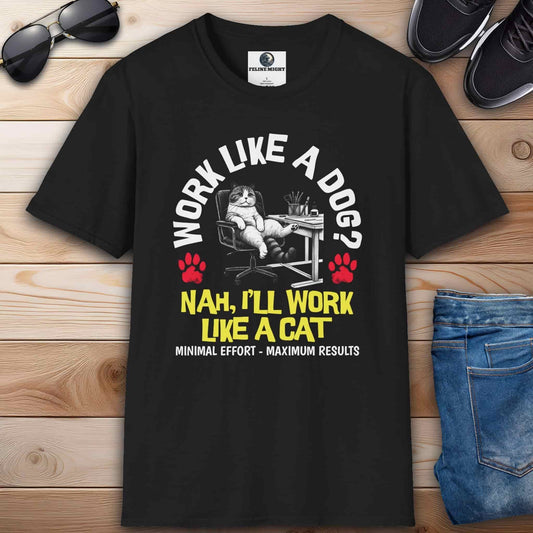 A black Funny Work Cat T-Shirt with a humorous cat graphic and the text 'Work like a dog? Nah, I'll work like a cat,' on a wooden surface with sunglasses and jeans.