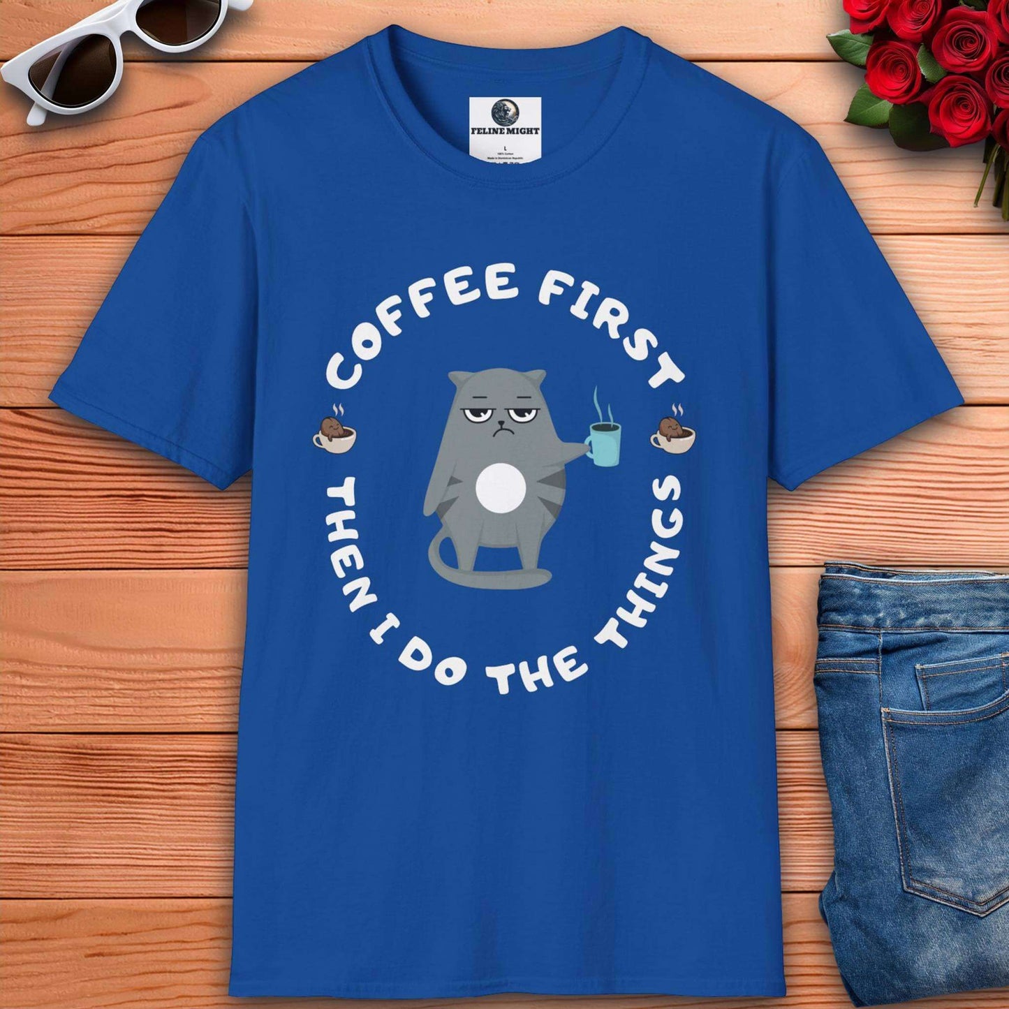 Royal blue t-shirt featuring a cartoon cat holding a coffee cup with the phrase 'Coffee First Then I Do The Things'