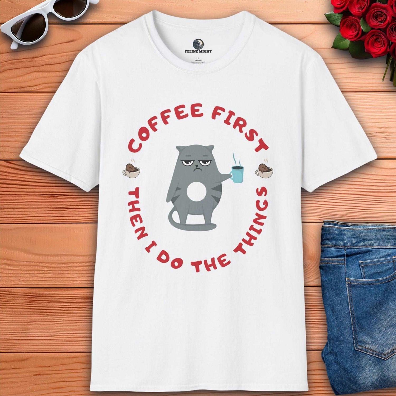 White t-shirt featuring a cartoon cat holding a coffee cup with the phrase 'Coffee First Then I Do The Things'