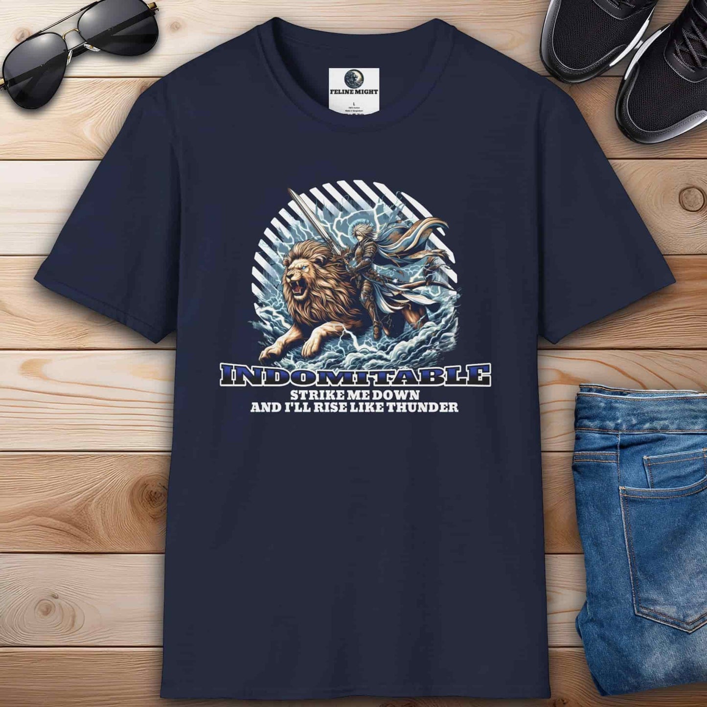A navy blue Indomitable Warrior Lion T-Shirt featuring a lion, a warrior, and the quote "Strike me down, and I'll rise like thunder" on a premium tee.