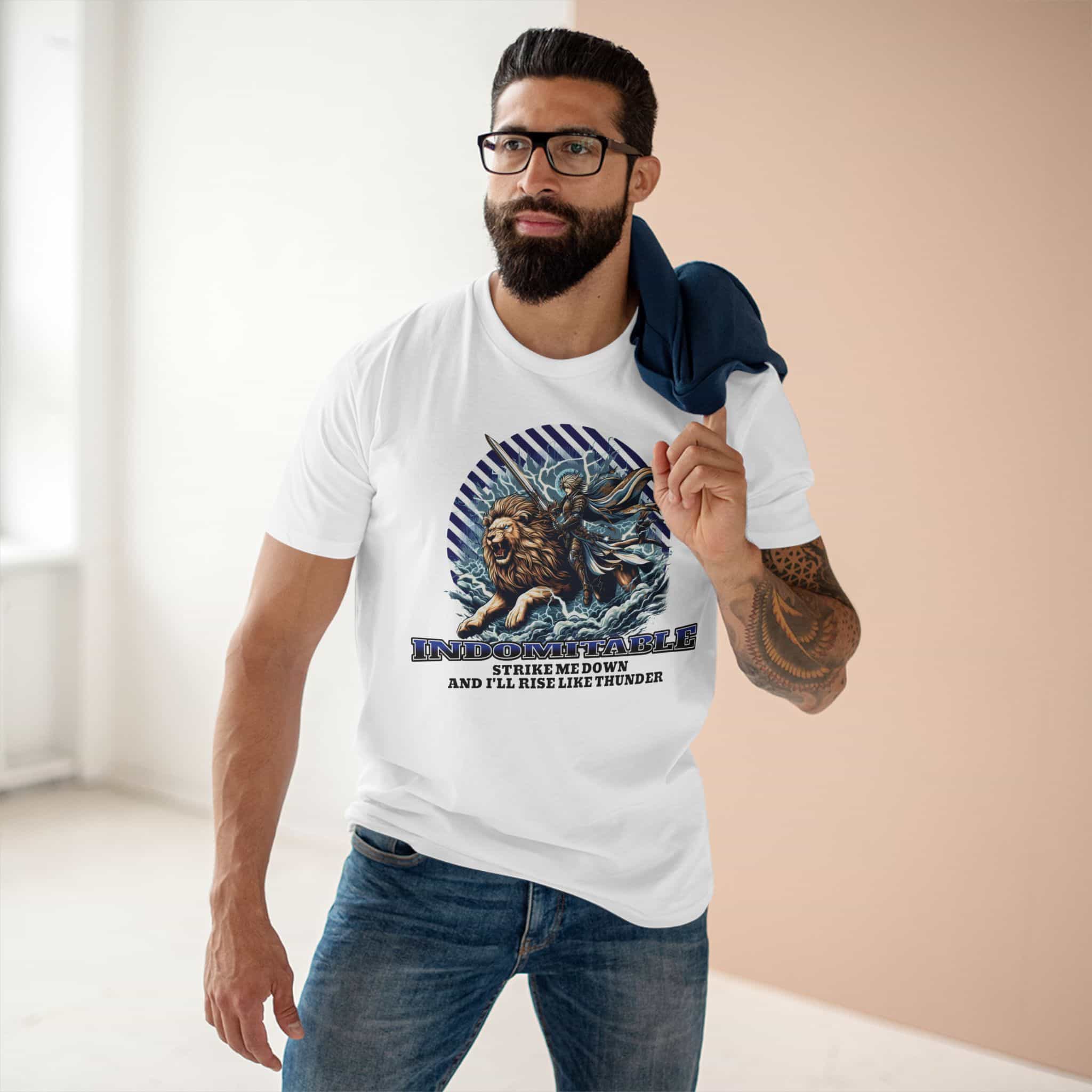 A man wearing a white "Indomitable Rise Like Thunder" Lion T-Shirt featuring a lion and warrior graphic with motivational quote.