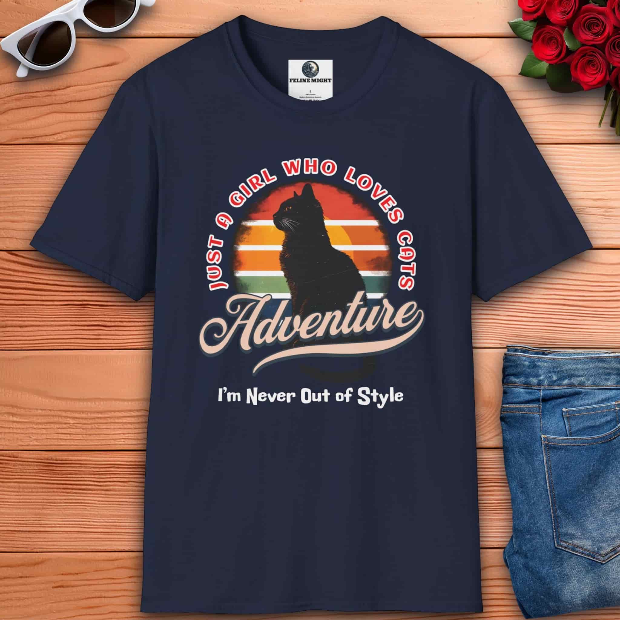 A navy blue Just a Girl Who Loves Cats T-Shirt featuring a cat silhouette, retro adventure design, and the text "I'm Never Out of Style."