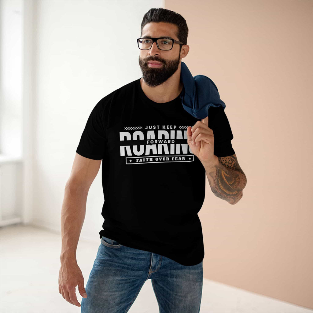 A black Just Keep Roaring Forward Quote Tee worn by a man in a casual setting, embodying strength and resilience.