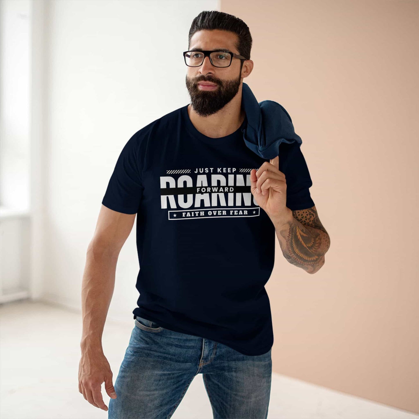 A navy blue Just Keep Roaring Forward T-Shirt worn by a man in a casual setting, embodying strength and resilience.