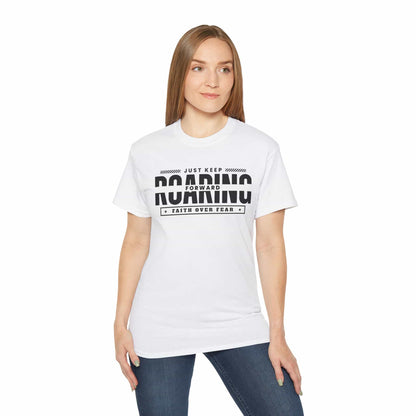 A white Just Keep Roaring Forward T-Shirt worn by a woman, embodying strength and resilience.