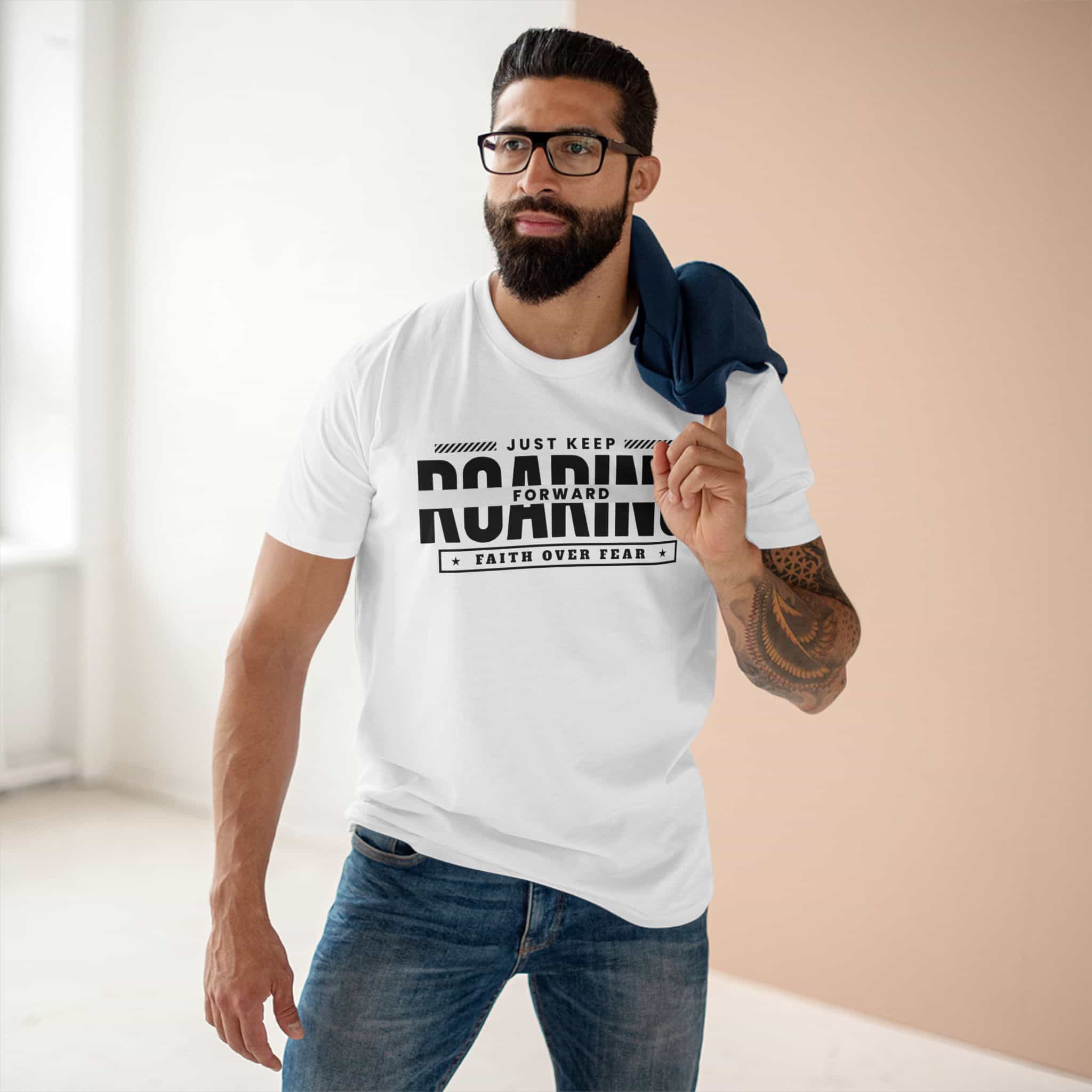 A white Just Keep Roaring Forward Quote Tee worn by a man in a casual setting, embodying strength and resilience.