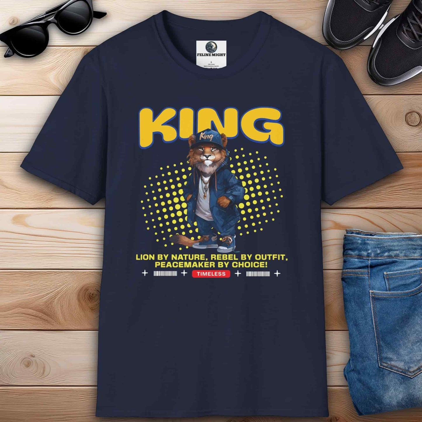 A stylish navy blue t-shirt featuring a lion character with the word 'KING' and a catchy slogan.