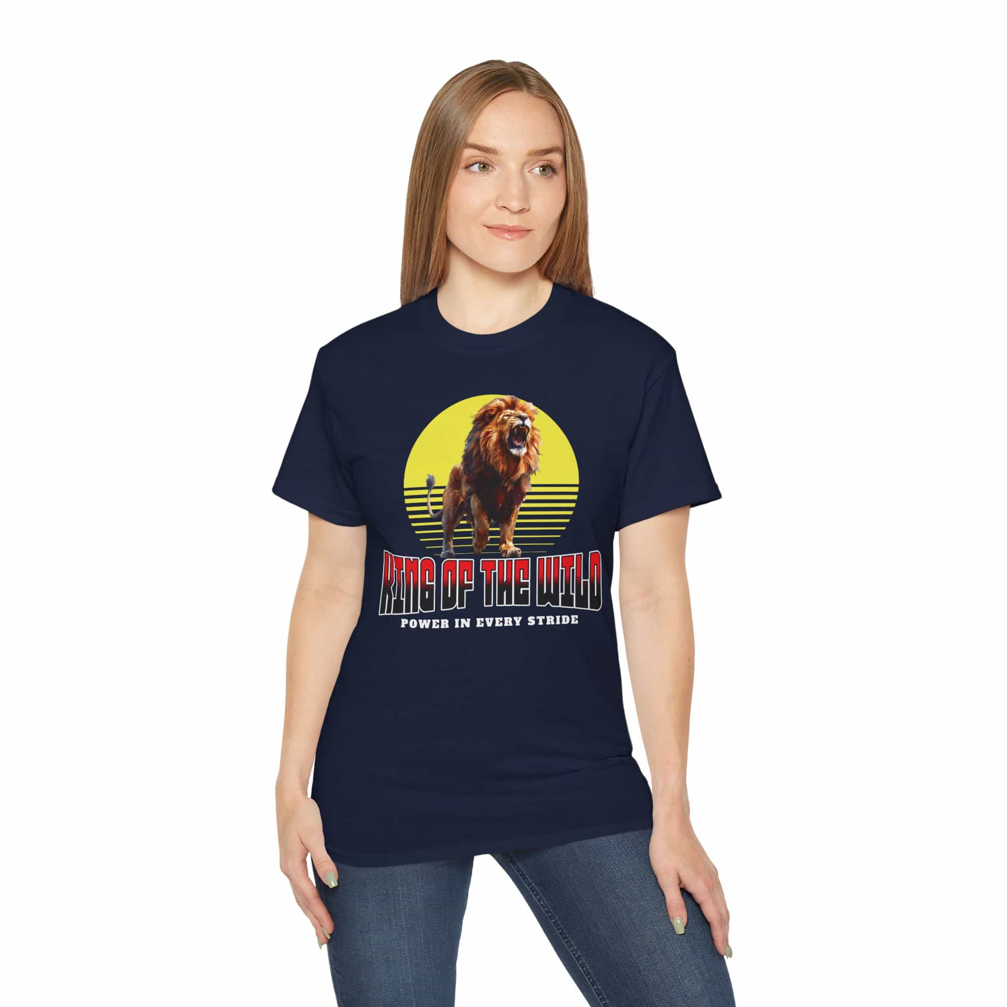 A woman wearing a navy blue King of the Wild Lion T-Shirt featuring a bold lion graphic with the text 'King of the Wild - Power in Every Stride'.