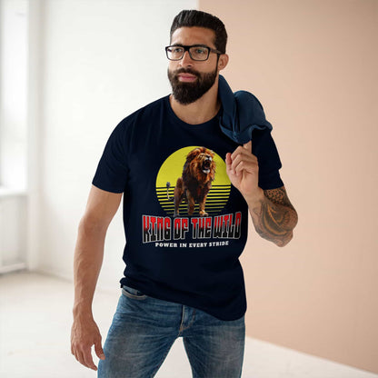 A man wearing a navy blue King of the Wild Lion T-Shirt featuring a bold lion graphic with the text 'Power in Every Stride'.