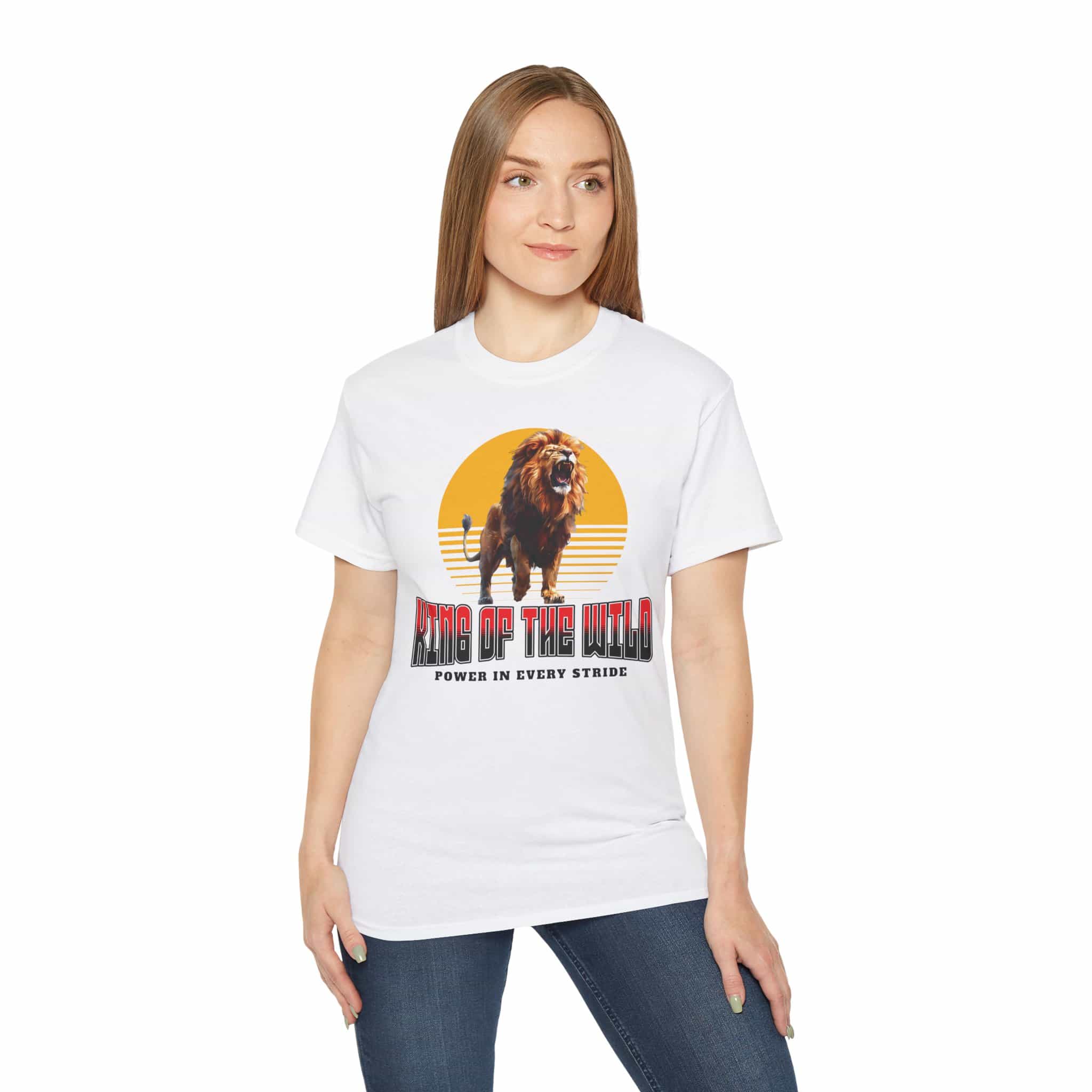 A woman wearing a white King of the Wild Lion T-Shirt featuring a bold lion graphic with the text 'King of the Wild - Power in Every Stride'.