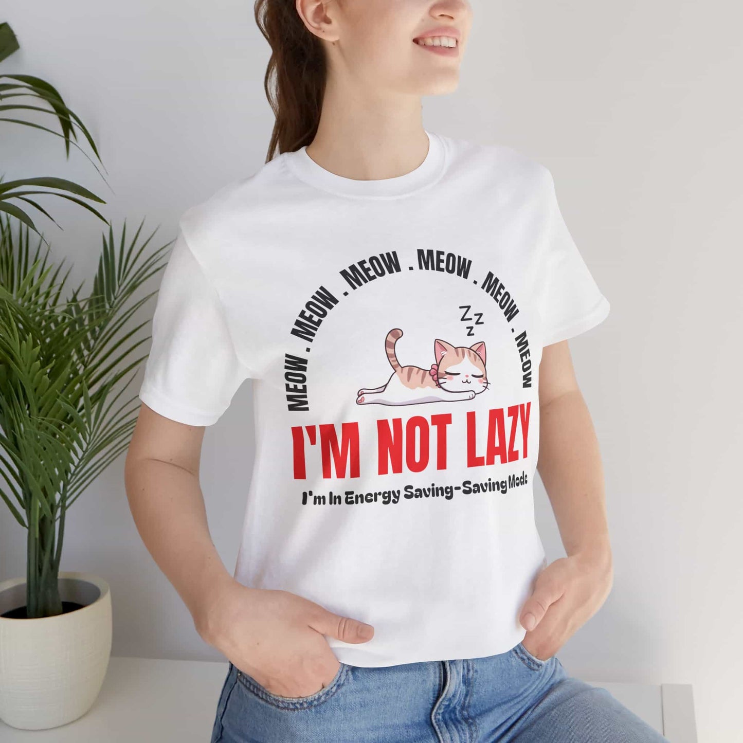 A woman wearing a white Lazy Cat Funny T-Shirt featuring a sleeping cat with text I'm Not Lazy, perfect for cat lovers and humorous fashion.